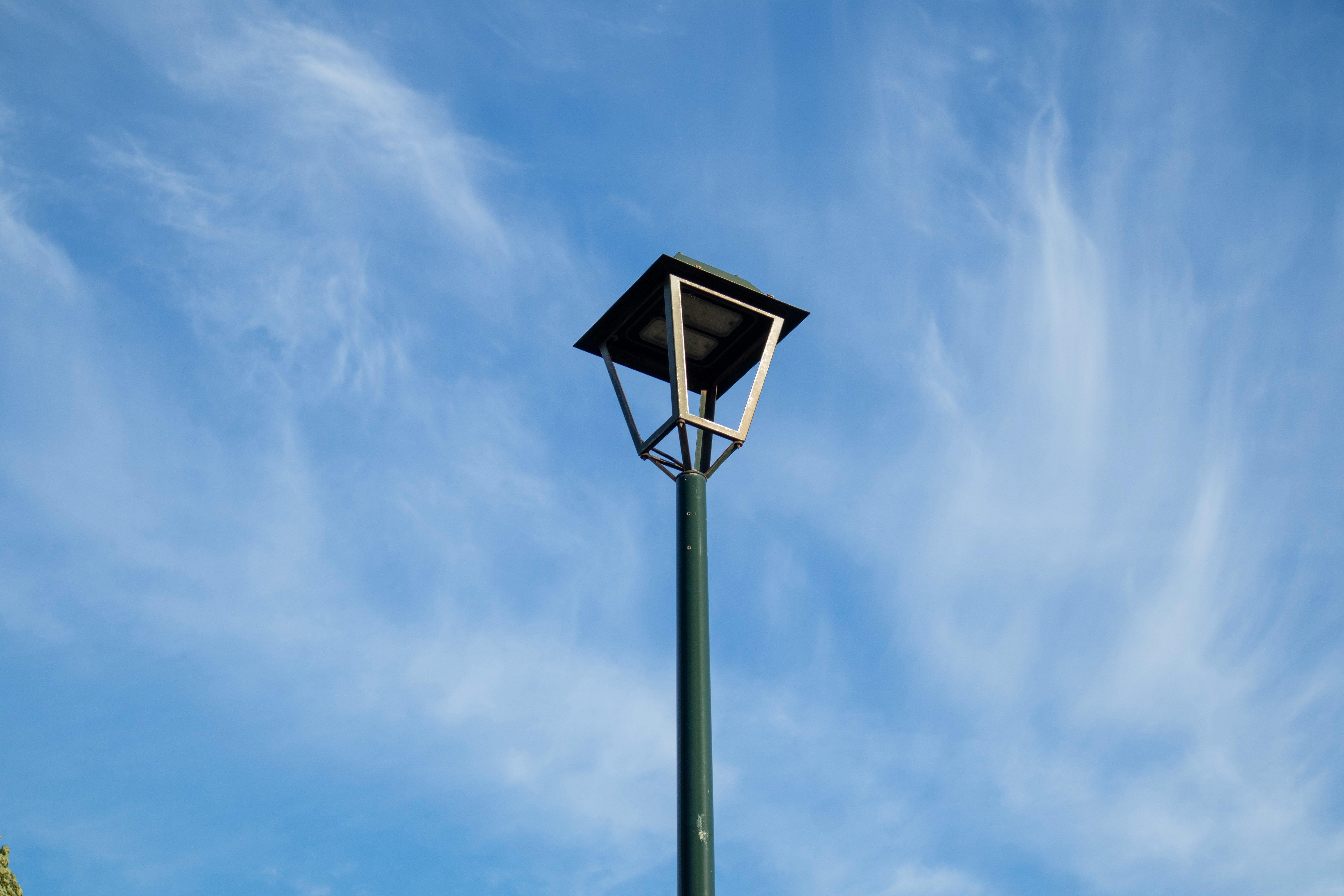 black and white street light under blue sky during daytime